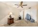 Bedroom featuring neutral carpet, a ceiling fan, a side table with a lamp, and a small heater at 19029 N 36Th St, Phoenix, AZ 85050