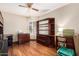 Bedroom with hardwood floors, a ceiling fan, a window, and a shelving unit at 19029 N 36Th St, Phoenix, AZ 85050