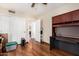 Bedroom featuring hardwood floors, two closets, a ceiling fan, and an attached office desk at 19029 N 36Th St, Phoenix, AZ 85050
