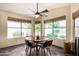 Bright breakfast nook with a ceiling fan and three large windows providing plenty of natural light and backyard views at 19029 N 36Th St, Phoenix, AZ 85050