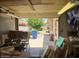 View of an open garage filled with boxes, equipment, and sunlight shining through the garage door at 19029 N 36Th St, Phoenix, AZ 85050