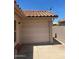 View of a closed garage door, featuring a tiled roof, and a stucco wall at 19029 N 36Th St, Phoenix, AZ 85050
