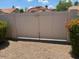 View of a gate, surrounded by foliage and gravel at 19029 N 36Th St, Phoenix, AZ 85050