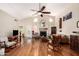 Cozy living room with hardwood floors, a fireplace, and a ceiling fan at 19029 N 36Th St, Phoenix, AZ 85050