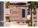 An aerial view of the home with solar panels on the roof, a large pool and mature landscaping at 1932 S Arroyo Ln, Gilbert, AZ 85295