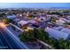Dusk aerial view of home highlighting the solar panels, backyard pool, and landscaping at 1932 S Arroyo Ln, Gilbert, AZ 85295