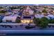 Aerial view of home with solar panels, a private pool, and mature landscaping at twilight at 1932 S Arroyo Ln, Gilbert, AZ 85295