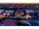 Aerial front view of the home at dusk, highlighting the well-manicured lawn and mature trees at 1932 S Arroyo Ln, Gilbert, AZ 85295