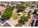An aerial view showcases a neighborhood park, featuring a shaded playground area, mature trees, and green spaces at 1932 S Arroyo Ln, Gilbert, AZ 85295
