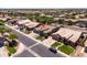 An aerial shot shows a home with mature trees and landscaping in a desirable neighborhood at 1932 S Arroyo Ln, Gilbert, AZ 85295