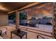 Outdoor seating area with a view of the pool and palm trees, ideal for entertaining at 1932 S Arroyo Ln, Gilbert, AZ 85295