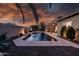 Serene backyard featuring a pristine pool with a relaxing waterfall feature at 1932 S Arroyo Ln, Gilbert, AZ 85295