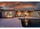 Resort-style backyard oasis with a pool and expansive patio, ideal for entertaining under the picturesque evening sky at 1932 S Arroyo Ln, Gilbert, AZ 85295