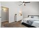 Bedroom with white dresser, ceiling fan, and view into open doorway at 1932 S Arroyo Ln, Gilbert, AZ 85295