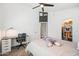 Bedroom with ceiling fan and a desk provides a comfortable and productive area at 1932 S Arroyo Ln, Gilbert, AZ 85295