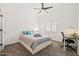 Bright bedroom offers a ceiling fan, shuttered windows, and carpeted floors at 1932 S Arroyo Ln, Gilbert, AZ 85295