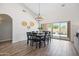 Dining room with a modern chandelier and sliding doors leading to the backyard pool at 1932 S Arroyo Ln, Gilbert, AZ 85295