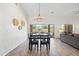 Open dining room with backyard views and wood-look tile floors at 1932 S Arroyo Ln, Gilbert, AZ 85295