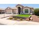Charming single-story home featuring a well-manicured front yard, tile roof, and a three-car garage at 1932 S Arroyo Ln, Gilbert, AZ 85295