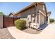Exterior shot showcasing the home's attached garage and gated side yard at 1932 S Arroyo Ln, Gilbert, AZ 85295