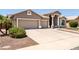 Charming single-story home showcasing a well-maintained lawn, tile roof, and a spacious three-car garage at 1932 S Arroyo Ln, Gilbert, AZ 85295
