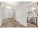 Bright foyer with wood-look flooring, double front doors, and access to a conveniently located powder room at 1932 S Arroyo Ln, Gilbert, AZ 85295