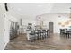 Modern kitchen with white cabinetry, a large island with seating, stainless steel appliances, and wood-look flooring at 1932 S Arroyo Ln, Gilbert, AZ 85295