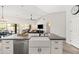 Modern kitchen features a large island, white cabinets, stainless steel appliances, and open floorplan at 1932 S Arroyo Ln, Gilbert, AZ 85295