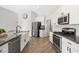 Well-equipped kitchen with stainless steel appliances, a farmhouse sink, and a spacious layout for cooking and entertaining at 1932 S Arroyo Ln, Gilbert, AZ 85295