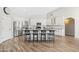Spacious kitchen featuring white cabinets, stainless steel appliances, a large island, and wood-look flooring at 1932 S Arroyo Ln, Gilbert, AZ 85295
