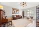 Comfortable living room showcasing stylish furniture, a ceiling fan, and natural light through the window at 1932 S Arroyo Ln, Gilbert, AZ 85295