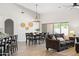 Inviting living room with shiplap accent wall, large windows, and comfortable seating, seamlessly connected to the dining area at 1932 S Arroyo Ln, Gilbert, AZ 85295