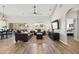Open-concept living room with wood floors, shiplap accent wall, and sliding glass doors to the backyard at 1932 S Arroyo Ln, Gilbert, AZ 85295