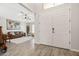 Inviting living space with wood-look floors, a large double door entrance, and comfortable seating at 1932 S Arroyo Ln, Gilbert, AZ 85295