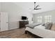 This main bedroom offers neutral walls, wood-look floors, and plantation shutters for natural light and privacy at 1932 S Arroyo Ln, Gilbert, AZ 85295