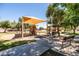 A shaded playground area is equipped with slides, climbing structures, benches, and a picnic area at 1932 S Arroyo Ln, Gilbert, AZ 85295