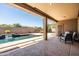 Backyard with pool and waterfall feature with seating area on the covered patio at 1932 S Arroyo Ln, Gilbert, AZ 85295