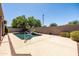 Sparkling pool featuring a rock waterfall feature and lush landscaping at 1932 S Arroyo Ln, Gilbert, AZ 85295