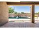 Inviting pool featuring a cascading waterfall surrounded by a wall of landscaping at 1932 S Arroyo Ln, Gilbert, AZ 85295