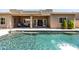 Backyard with pool and covered patio, an excellent setting for relaxation and entertainment at 1932 S Arroyo Ln, Gilbert, AZ 85295