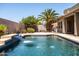 Gorgeous pool with cascading waterfall and desert landscaping at 1932 S Arroyo Ln, Gilbert, AZ 85295