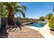 Backyard pool with mature landscaping and privacy wall, offering a private oasis at 1932 S Arroyo Ln, Gilbert, AZ 85295
