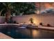 Tranquil pool featuring a custom waterfall, enhancing the backyard's ambiance with soothing sounds and elegant design at 1932 S Arroyo Ln, Gilbert, AZ 85295