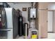 Storage room with stainless fridge, water heater, and utility sink at 1932 S Arroyo Ln, Gilbert, AZ 85295