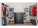 Organized walk-in closet with shelving on both sides and a dark chest of drawers in the center at 1932 S Arroyo Ln, Gilbert, AZ 85295