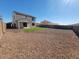 Spacious backyard featuring decorative rock, artificial turf, and block wall for privacy at 19889 W Annika Dr, Litchfield Park, AZ 85340