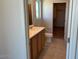 Well-lit bathroom featuring a sink, vanity, toilet, and closet space at 19889 W Annika Dr, Litchfield Park, AZ 85340