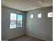 Bright bedroom with large windows offering natural light and neighborhood views at 19889 W Annika Dr, Litchfield Park, AZ 85340