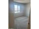 Serene bedroom with plush carpet and a bright window creating a relaxing atmosphere at 19889 W Annika Dr, Litchfield Park, AZ 85340