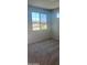 Cozy bedroom featuring neutral carpet and a large window for ample sunlight at 19889 W Annika Dr, Litchfield Park, AZ 85340